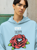 Load image into Gallery viewer, Man wearing a Stay Trippy   – Baby Blue Unisex Printed Hoodie