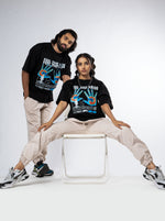Load image into Gallery viewer, Feel the Pain Black Unisex Oversized T-Shirt Front View Of Male and Female