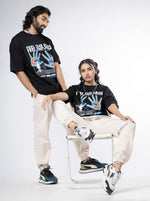 Load image into Gallery viewer, Feel the Pain Black Unisex Oversized T-Shirt Front View Of Male and Female
