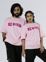 Load image into Gallery viewer, Be Kind Soft Pink Unisex Oversized T Shirt front  design view of male and female