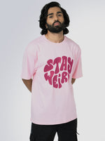 Load image into Gallery viewer, Stay Weird Soft Pink Unisex Oversized T-Shirt Front View Of Male
